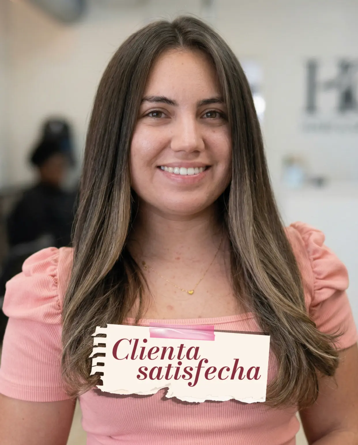 Client with long, sleek blown-out hair and blended highlights at Dominican Spa & Salon